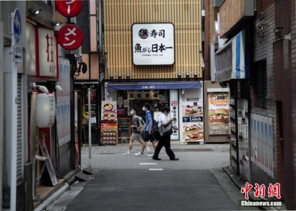 图为疫情下，民众走过日本东京一家寿司店。 <a target='_blank' href='http://www.chinanews.com/'>中新社</a>记者 吕少威 摄
