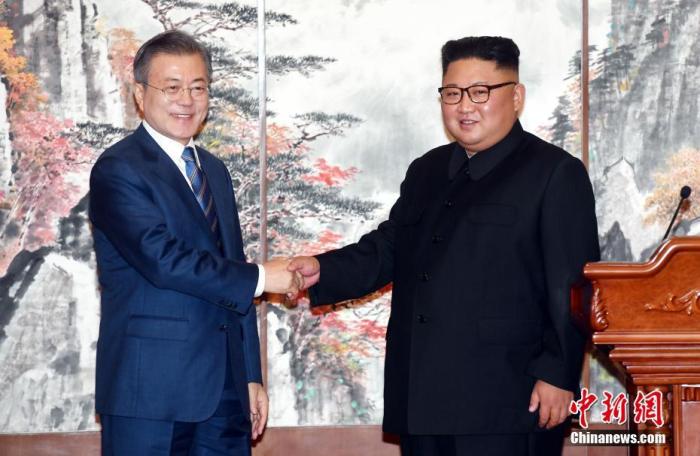 2018年9月19日，在朝鲜平壤，朝鲜国务委员会委员长金正恩(右)与韩国总统文在寅在举行共同记者会后握手。中新社发 平壤联合采访团供图
