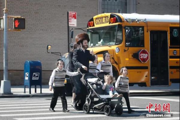 资料图：当地时间5月17日，民众从美国纽约市犹太社区的一所学校外经过。(廖攀 摄)