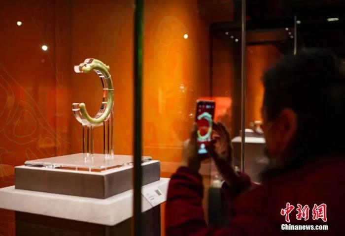 2022年1月26日，“何以中国”展在北京故宫博物院举行。图为观众欣赏故宫博物院藏红山文化“玉龙”展品。<a target='_blank' href='http://www.chinanews.com/'>中新社</a>记者 侯宇 摄